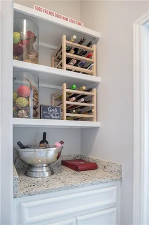 a bedroom with a bed and a lamp on dresser