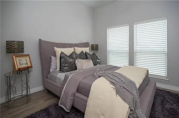 a bathroom with a granite countertop sink mirror vanity and toilet