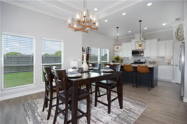 a view of a dining room with furniture window and wooden floor