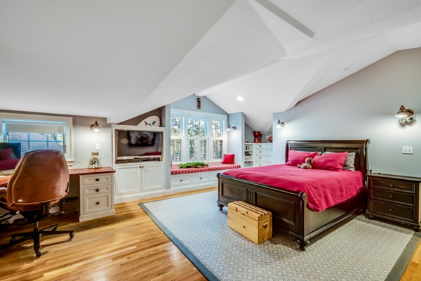 44 Myopia Road Winchester, MA 01890 - Photo 18 of 30 a bedroom with a bed a flat screen tv and dresser in it