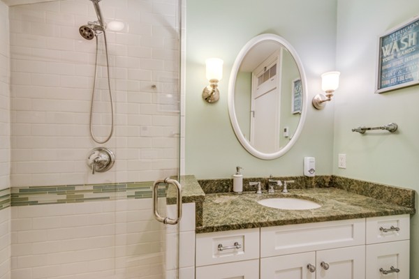 44 Myopia Road Winchester, MA 01890 - Photo 21 of 30 a bathroom with a granite countertop sink a mirror and a shower