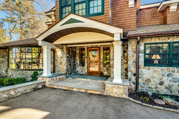 44 Myopia Road Winchester, MA 01890 - Photo 3 of 30 a front view of a house with a yard outdoor seating and garage