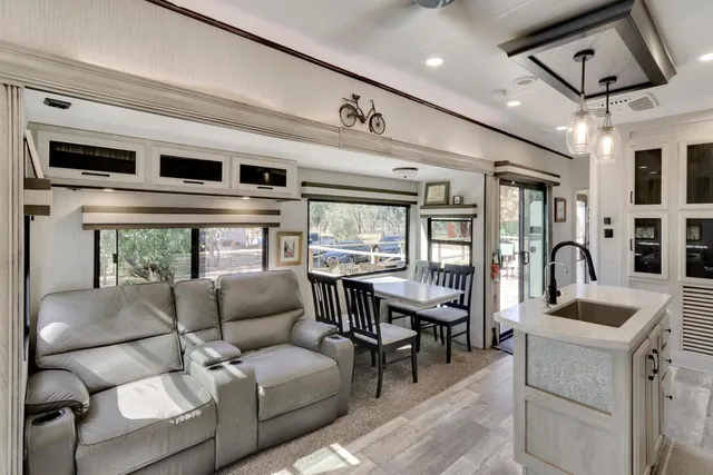 a kitchen with a stove a faucet a dining table and chairs