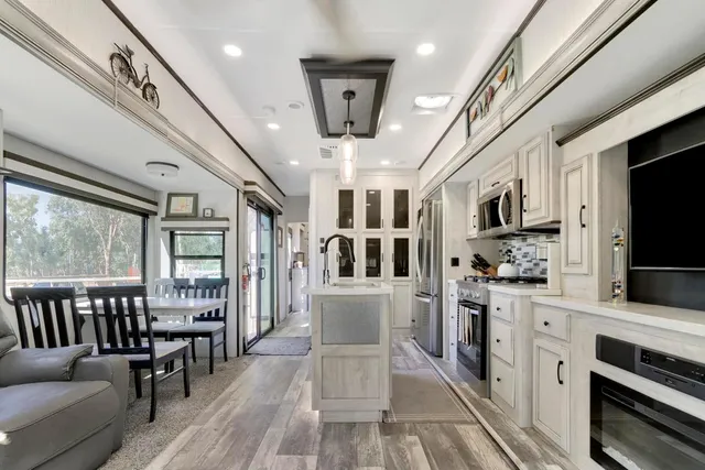 a view of kitchen with sink microwave and refrigerator