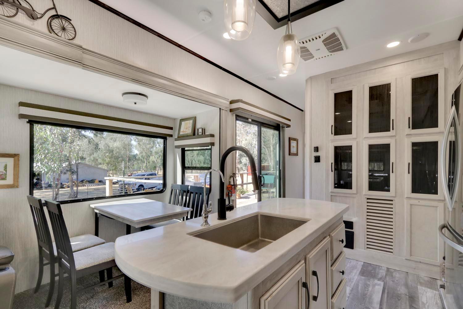13435 Bennett Road Herald, CA 95638 - Photo 16 of 80 a kitchen with a stove a faucet a dining table and chairs