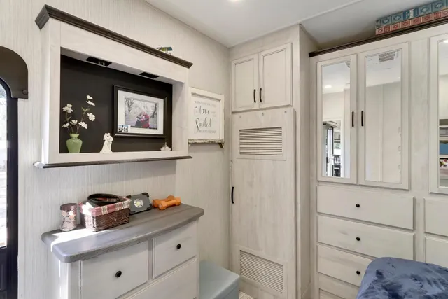 a view of backyard with large tree and wooden fence