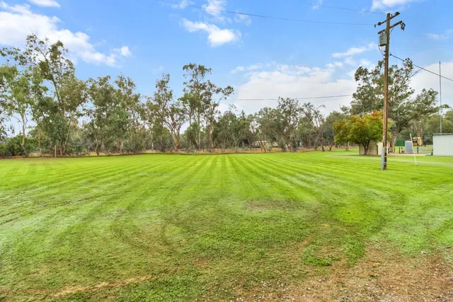 a backyard of a house with a table and chairs