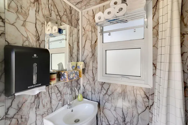 an aerial view of a house with a yard and lake view