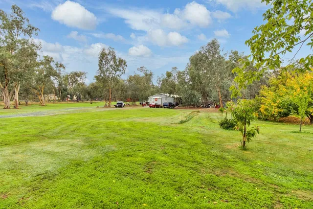 a backyard of a house with a yard and outdoor seating