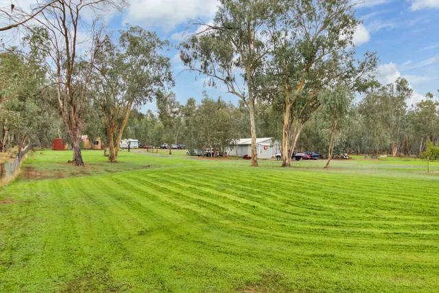 a view of a house with a big yard and large garden