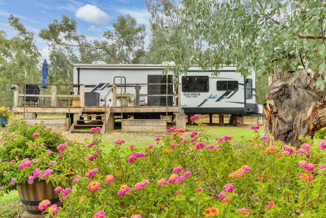 a view of a house with backyard porch and sitting area