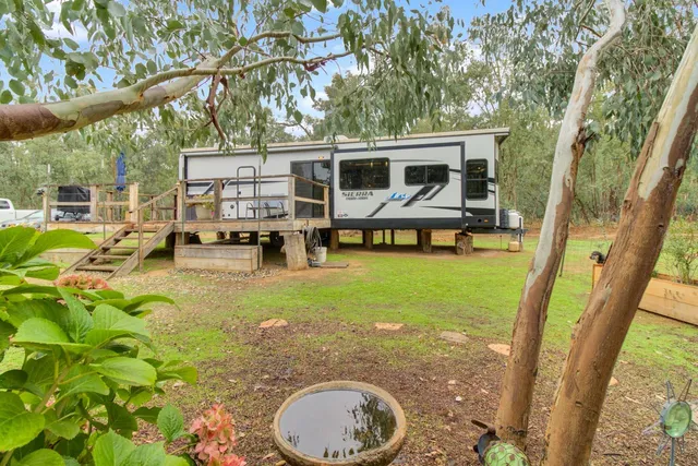 a kitchen with stainless steel appliances granite countertop a refrigerator a stove a sink dishwasher a dining table and chairs with wooden floor