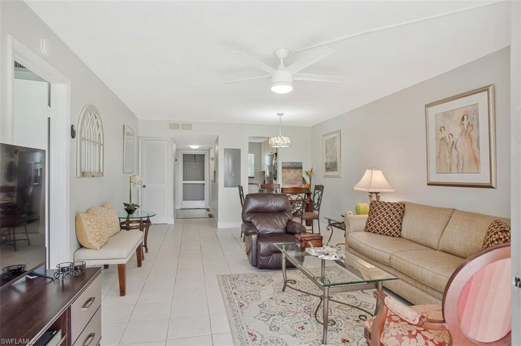 4380 27th Court Southwest, Unit 1 Naples, FL 34116 - Photo 16 of 34 Living room featuring light tile patterned flooring and a ceiling fan
