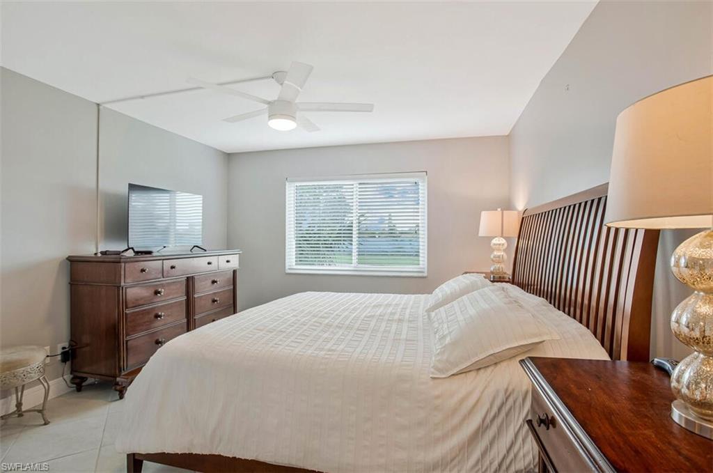 4380 27th Court Southwest, Unit 1 Naples, FL 34116 - Photo 20 of 34 Bedroom featuring a ceiling fan and tile patterned flooring