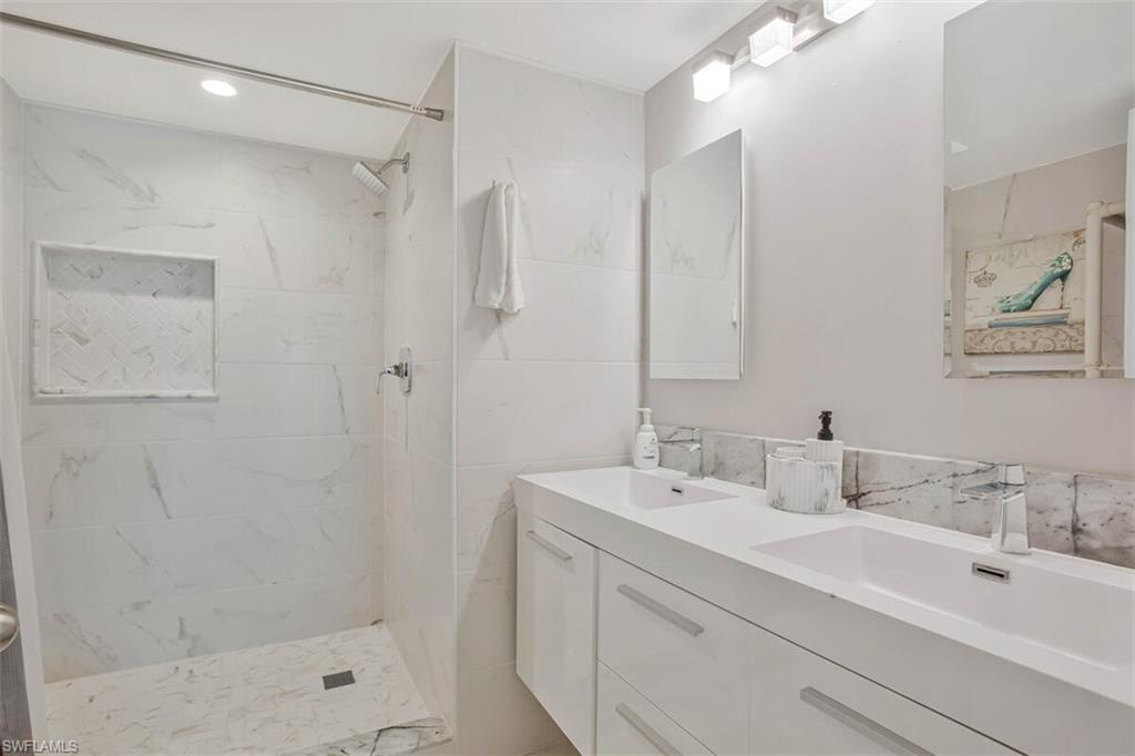 4380 27th Court Southwest, Unit 1 Naples, FL 34116 - Photo 21 of 34 Bathroom featuring a marble finish shower, double vanity, and recessed lighting