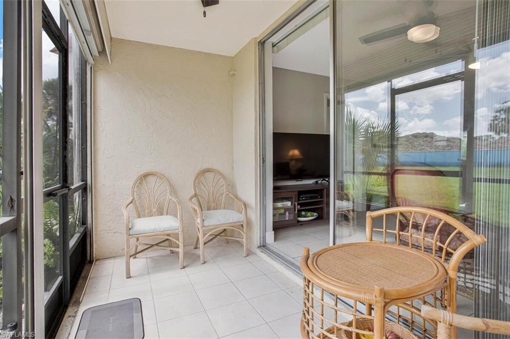 4380 27th Court Southwest, Unit 1 Naples, FL 34116 - Photo 22 of 34 Sunroom / solarium with tile patterned flooring and a textured wall