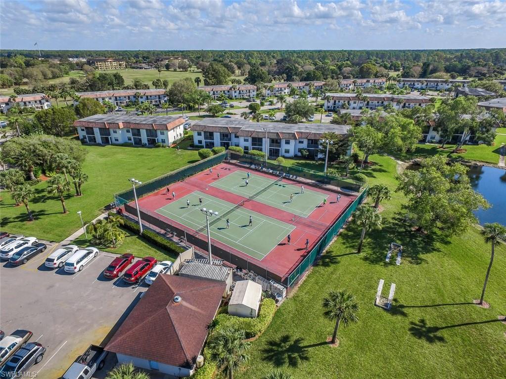 4380 27th Court Southwest, Unit 1 Naples, FL 34116 - Photo 28 of 34 Aerial view of pickleball/ tennis partial view of lake