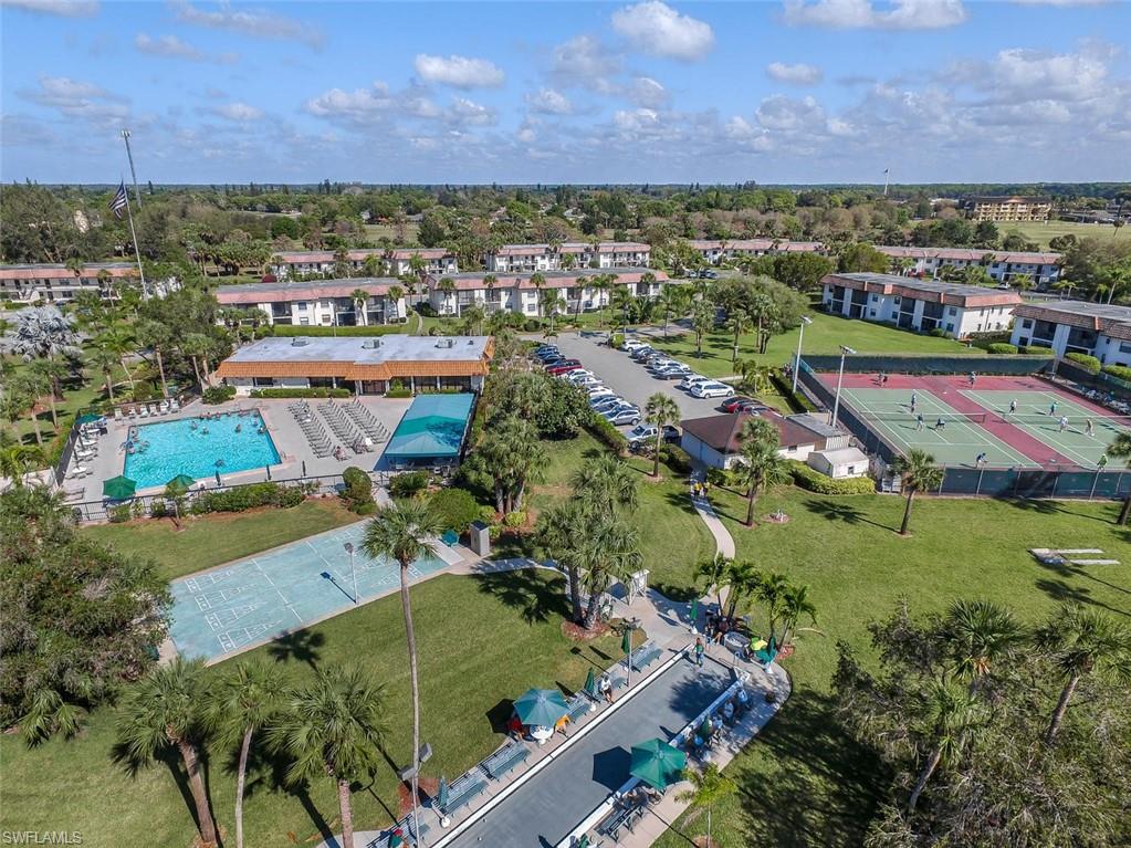 4380 27th Court Southwest, Unit 1 Naples, FL 34116 - Photo 33 of 34 Heated pool, shade canopy, club house, bocce court, tennis, pickleball are steps across the private circular road