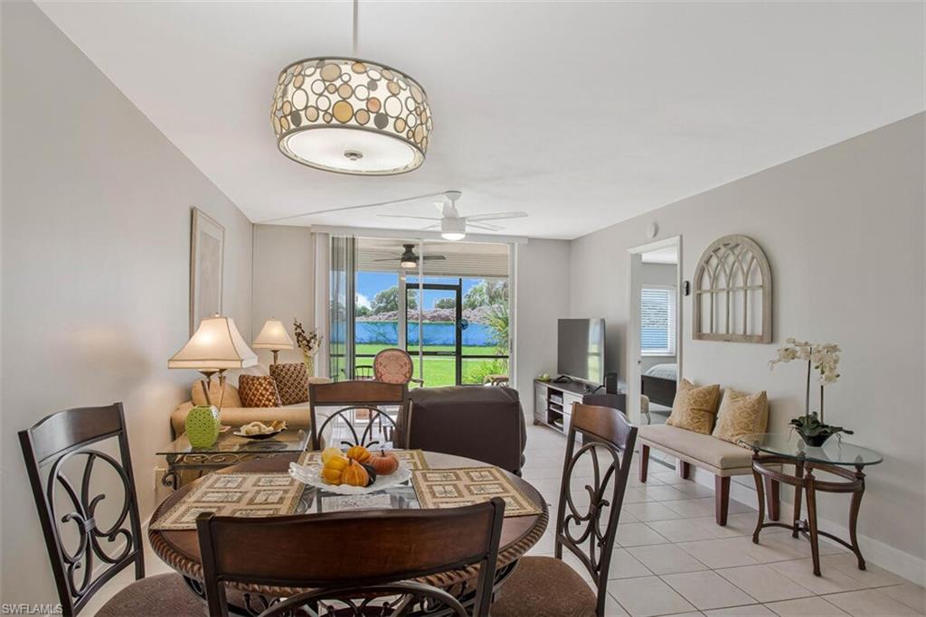 4380 27th Court Southwest, Unit 1 Naples, FL 34116 - Photo 9 of 34 Dining room featuring light tile patterned flooring and a ceiling fan