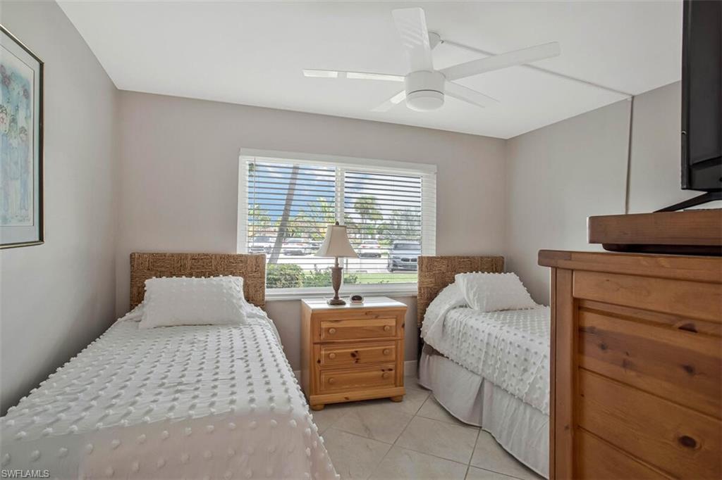 4380 27th Court Southwest, Unit 1 Naples, FL 34116 - Photo 10 of 34 Bedroom with twin beds,closet and a 3 piece bath right next door