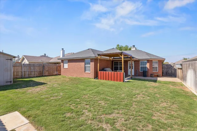 a view of a house with a yard and sitting area