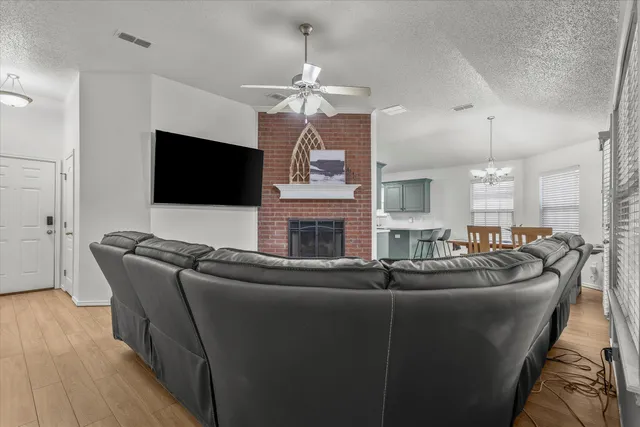 a living room with fireplace furniture and a flat screen tv