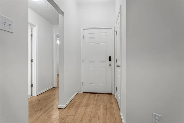 a view of a hallway with wooden floor