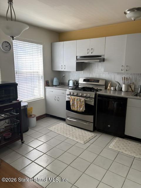 243 Pond Way, Unit B Staten Island, NY 10303 - Photo 3 of 10 a kitchen with stainless steel appliances granite countertop a stove a sink and a microwave