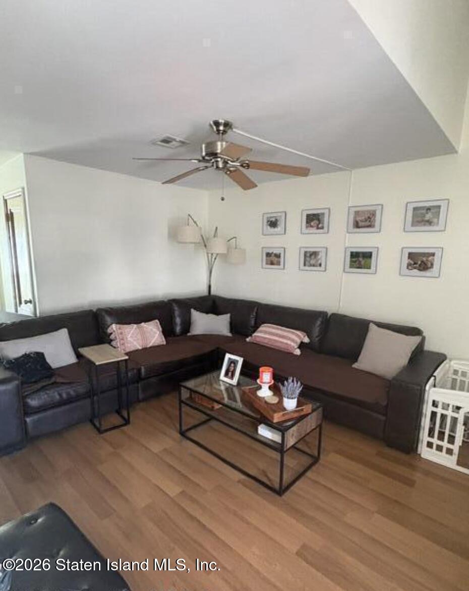 243 Pond Way, Unit B Staten Island, NY 10303 - Photo 5 of 10 a living room with furniture a rug and a table