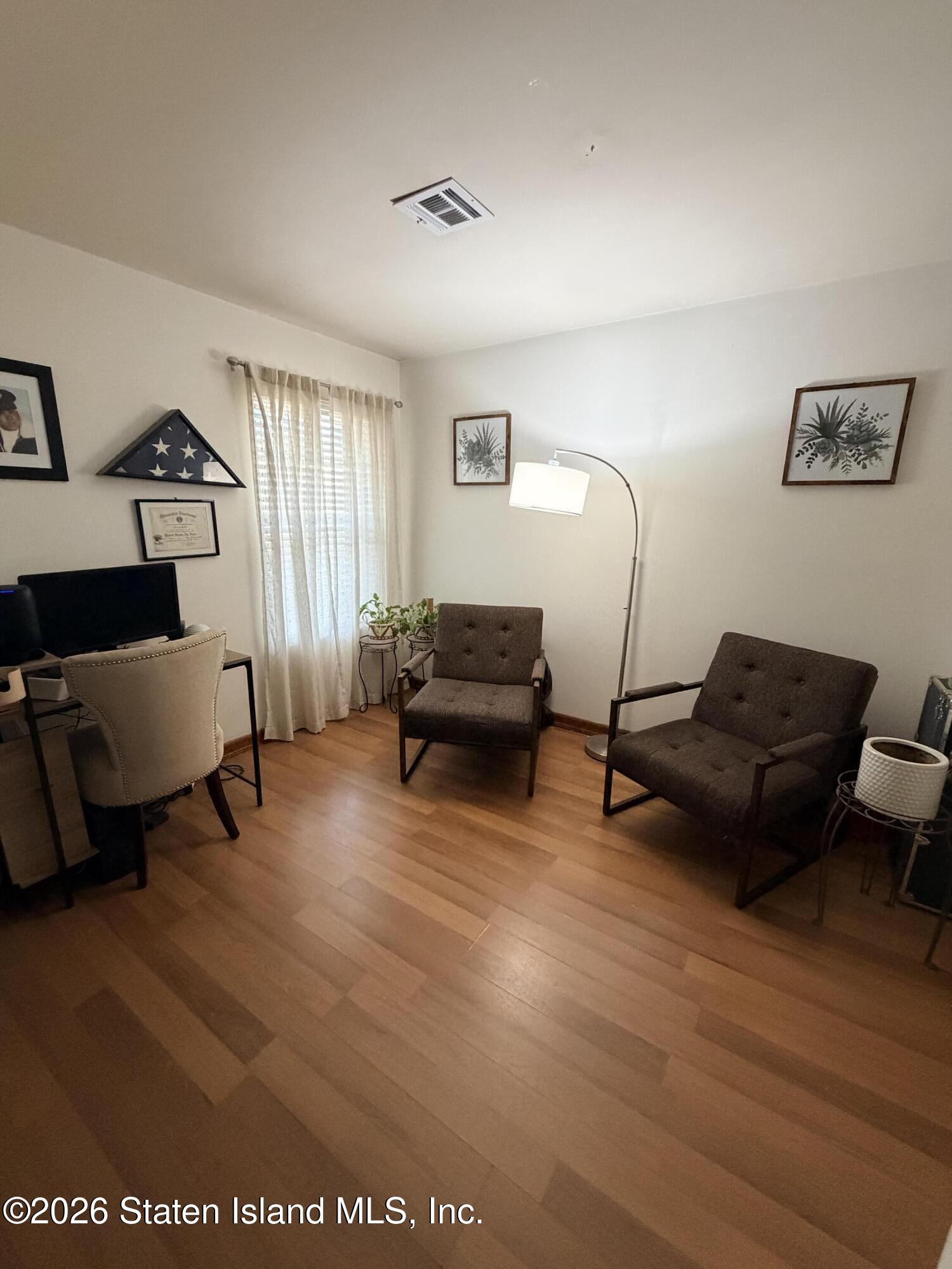 243 Pond Way, Unit B Staten Island, NY 10303 - Photo 7 of 10 a living room with furniture and a wooden floor