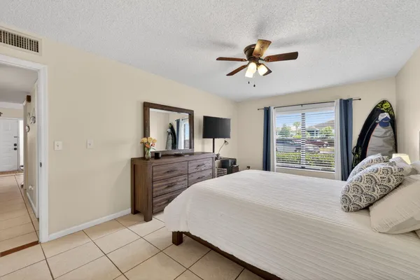 a bedroom with a large bed and a window