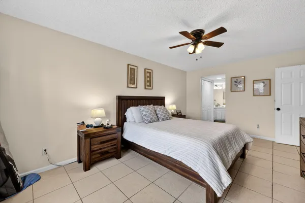 a bedroom with bed and paintings on the wall