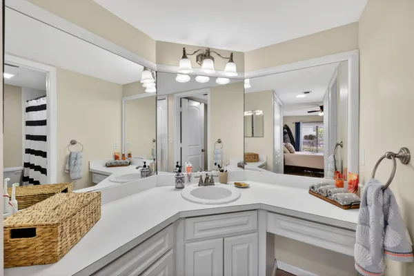 a bathroom with a double vanity sink mirror and shower