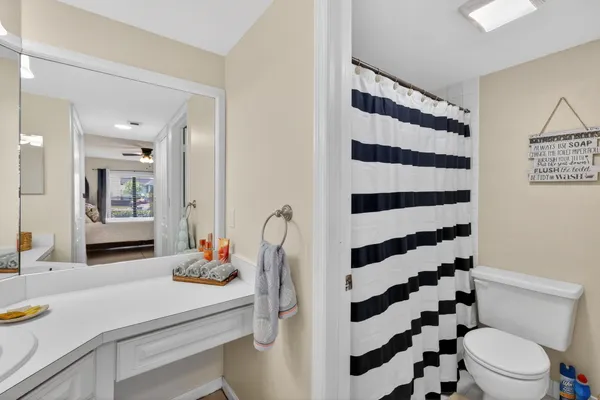 a bathroom with a sink a toilet a shower and a mirror