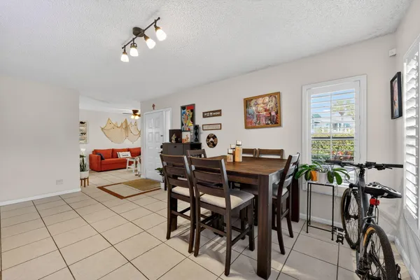 a view of a dining room with furniture and chandelier