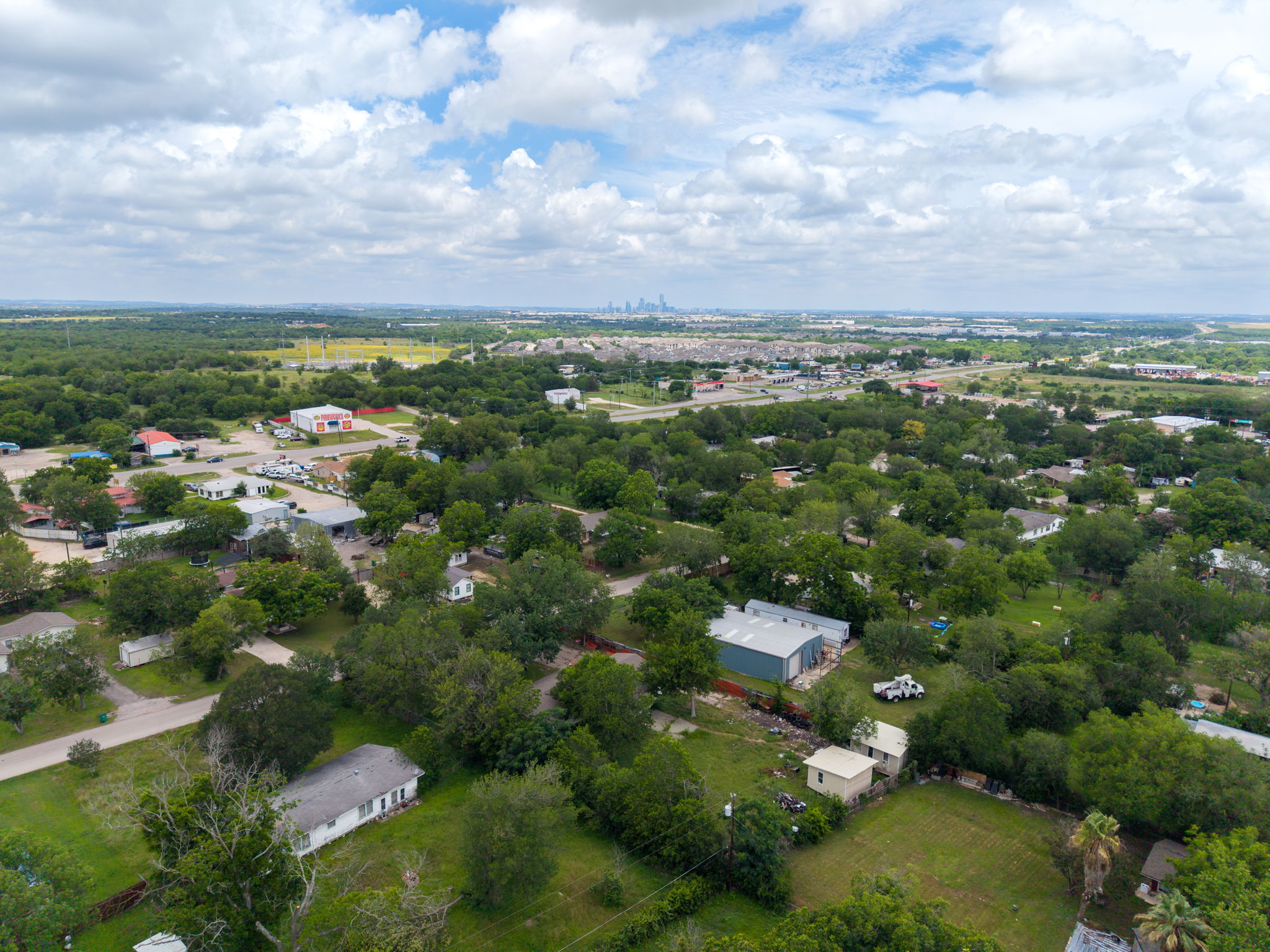 6803 Viewing Place Austin, TX 78719 - Photo 7 of 20 An aerial perspective reveals a verdant landscape dotted with homes, offering a tranquil community setting.