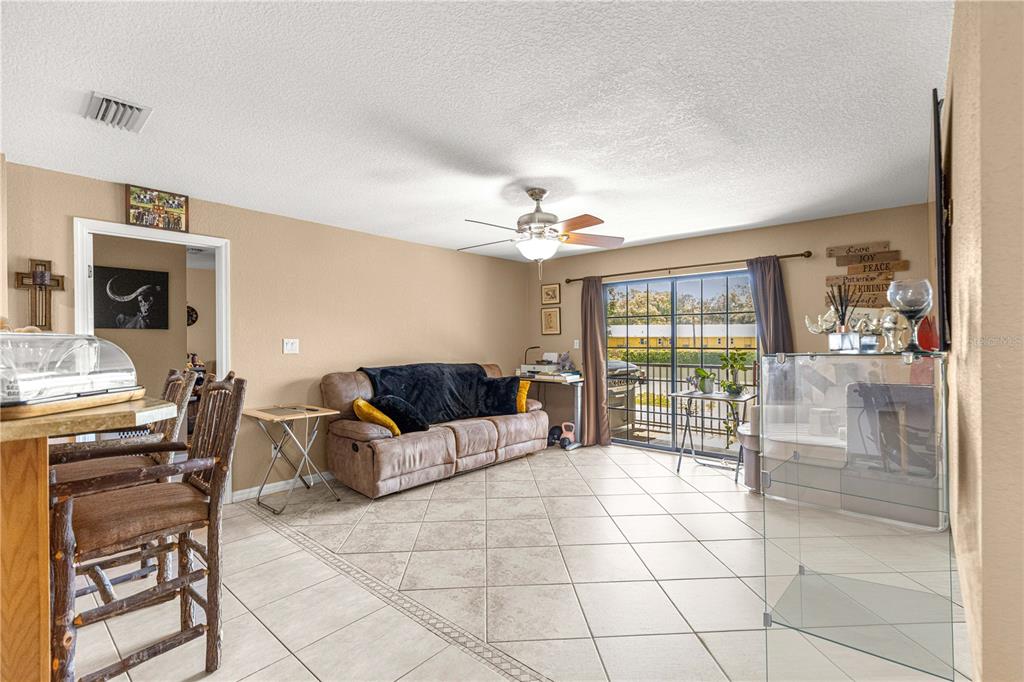 2837 Northeast 3rd Street, Unit 203 Ocala, FL 34470 - Photo 13 of 41 a living room with furniture and a fireplace