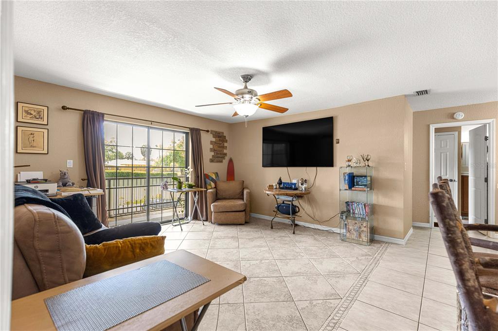 2837 Northeast 3rd Street, Unit 203 Ocala, FL 34470 - Photo 14 of 41 a living room with furniture and a flat screen tv