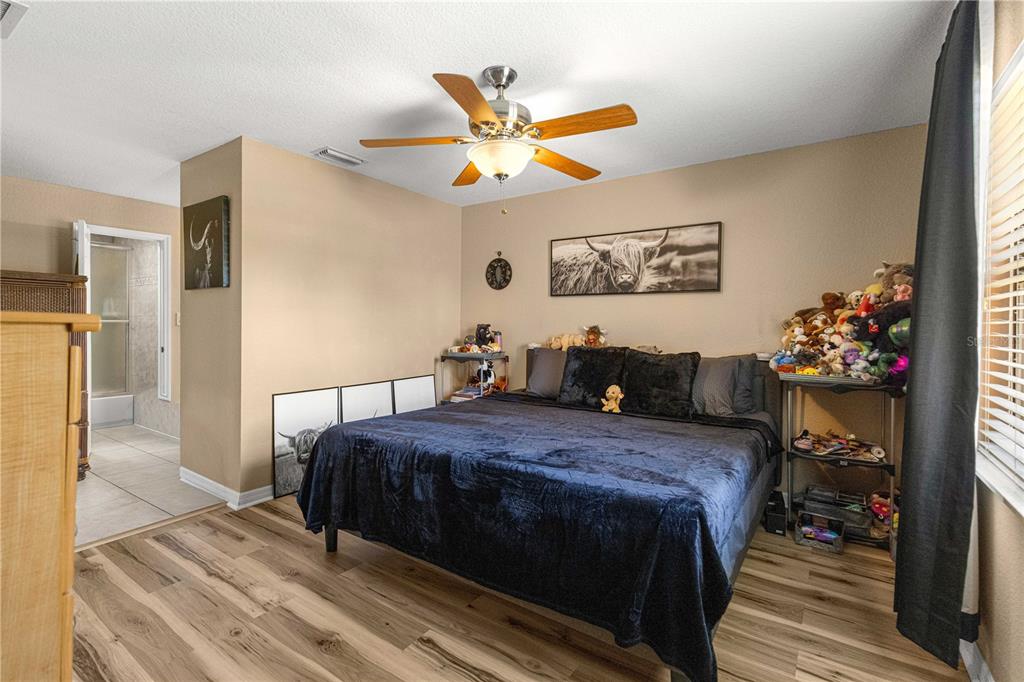 2837 Northeast 3rd Street, Unit 203 Ocala, FL 34470 - Photo 19 of 41 a bed room with a bed and a ceiling fan