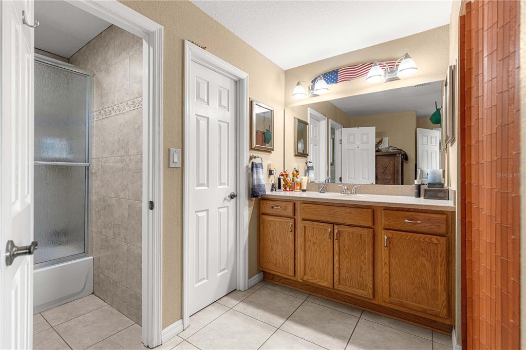 2837 Northeast 3rd Street, Unit 203 Ocala, FL 34470 - Photo 20 of 41 a bathroom with a double vanity sink and a mirror