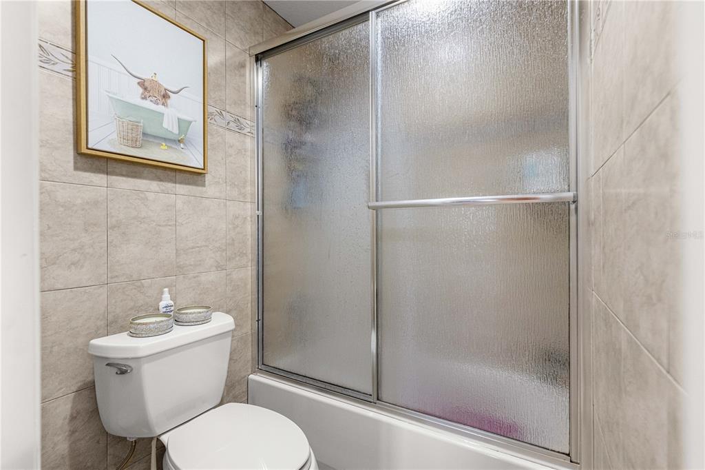 2837 Northeast 3rd Street, Unit 203 Ocala, FL 34470 - Photo 21 of 41 a white toilet sitting next to a bathroom sink