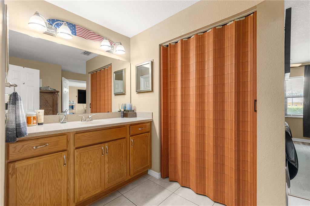 2837 Northeast 3rd Street, Unit 203 Ocala, FL 34470 - Photo 23 of 41 a bathroom with a double vanity sink and mirror