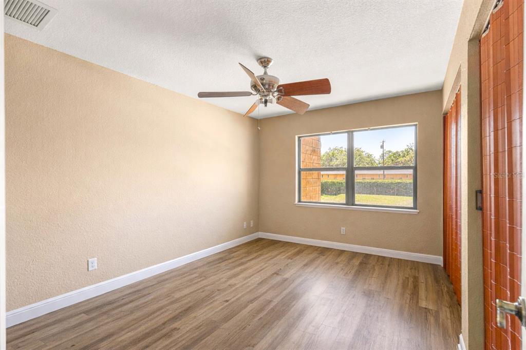 2837 Northeast 3rd Street, Unit 203 Ocala, FL 34470 - Photo 24 of 41 wooden floor in an empty room with a window
