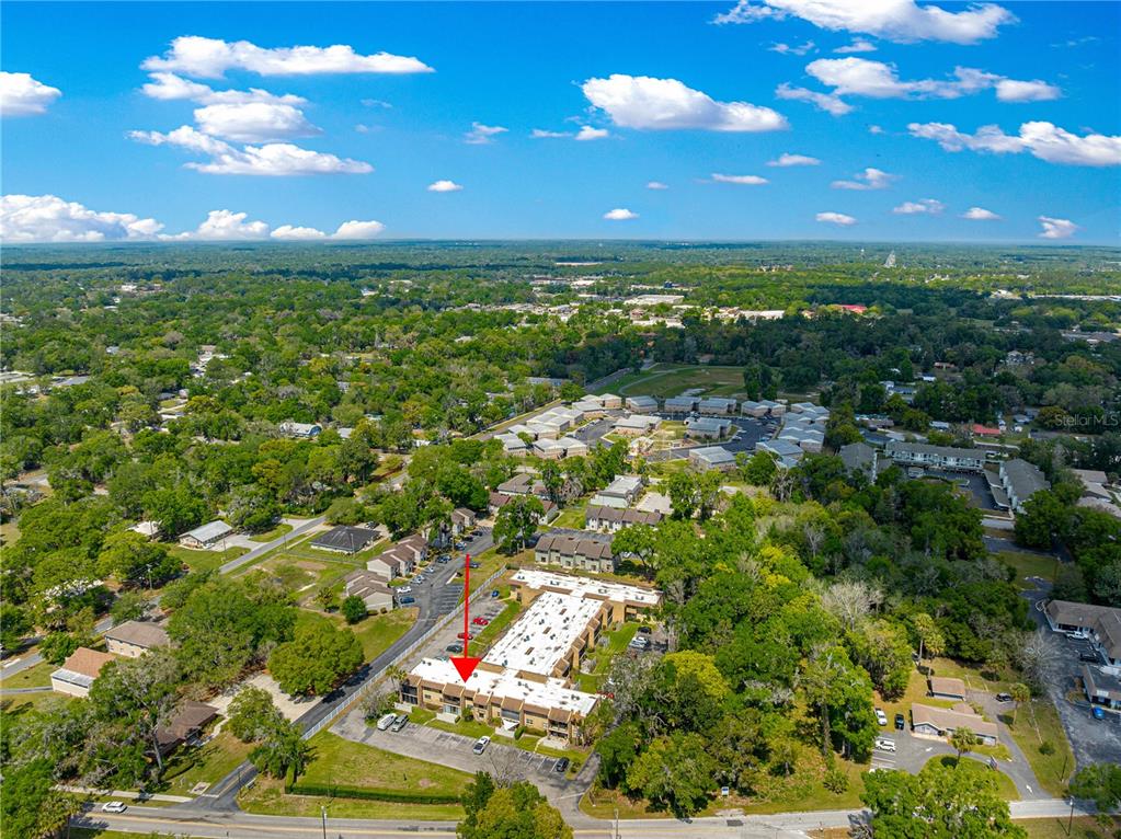 2837 Northeast 3rd Street, Unit 203 Ocala, FL 34470 - Photo 39 of 41 an aerial view of residential houses with outdoor space and trees