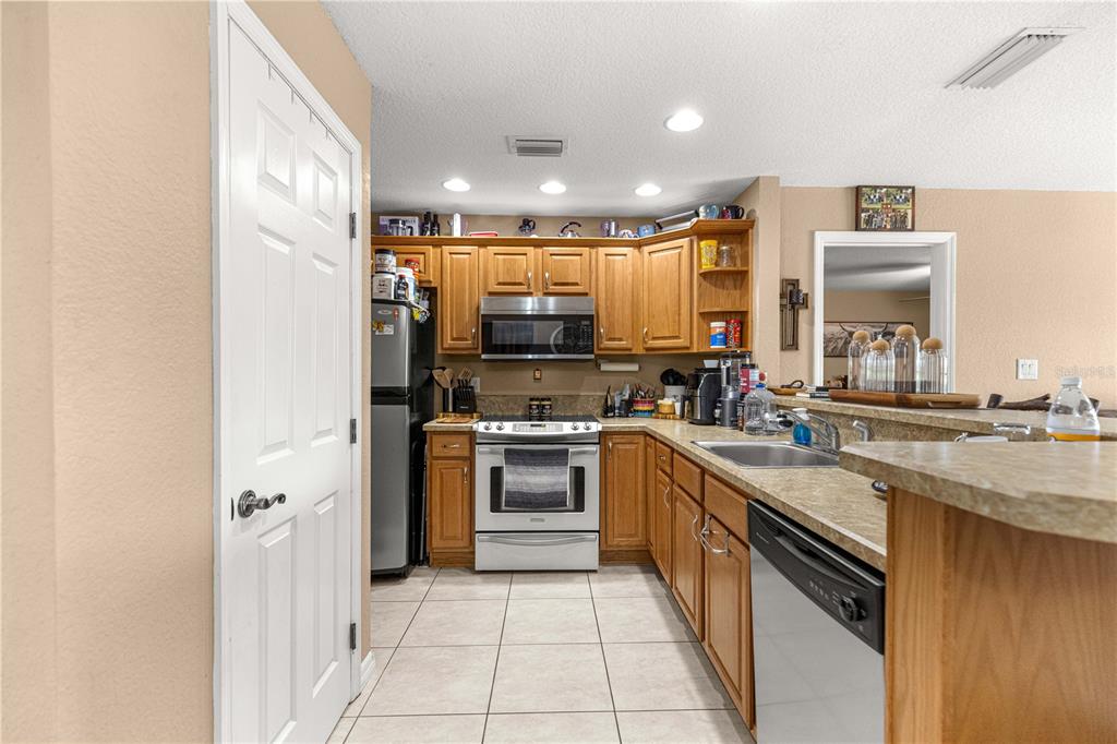 2837 Northeast 3rd Street, Unit 203 Ocala, FL 34470 - Photo 9 of 41 a large kitchen with stainless steel appliances granite countertop a refrigerator and a sink