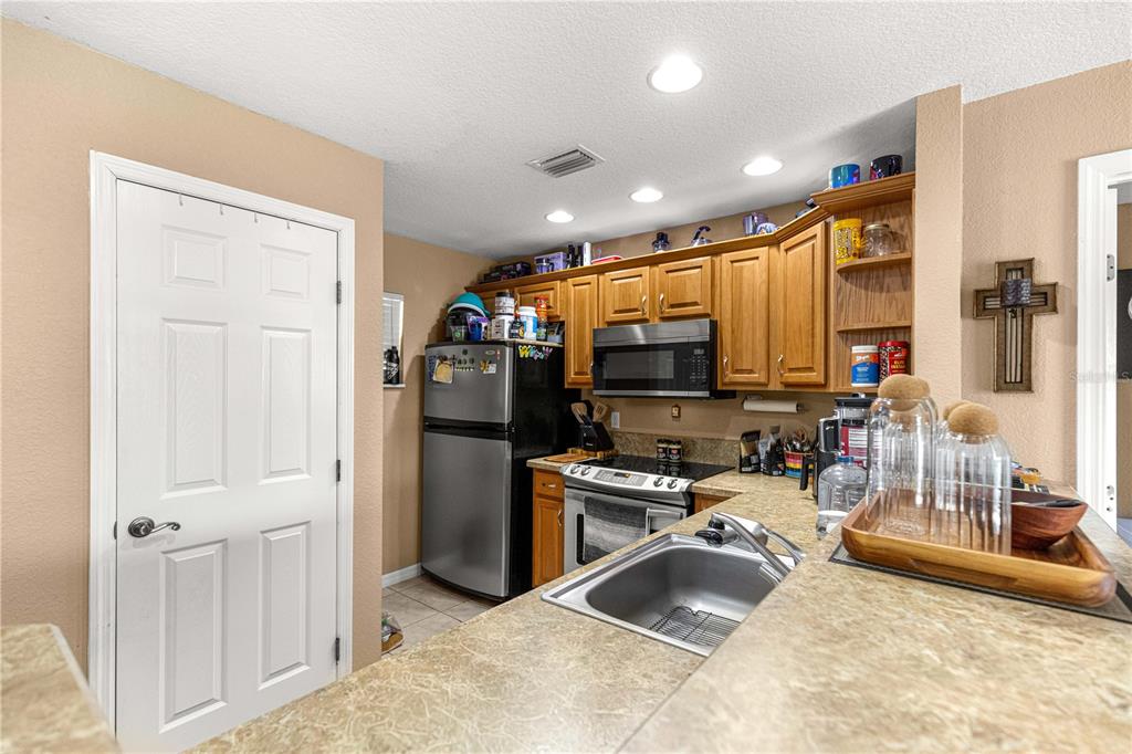 2837 Northeast 3rd Street, Unit 203 Ocala, FL 34470 - Photo 10 of 41 a kitchen with stainless steel appliances granite countertop a refrigerator and a sink