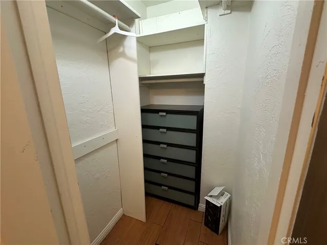 a view of walk in closet with empty racks
