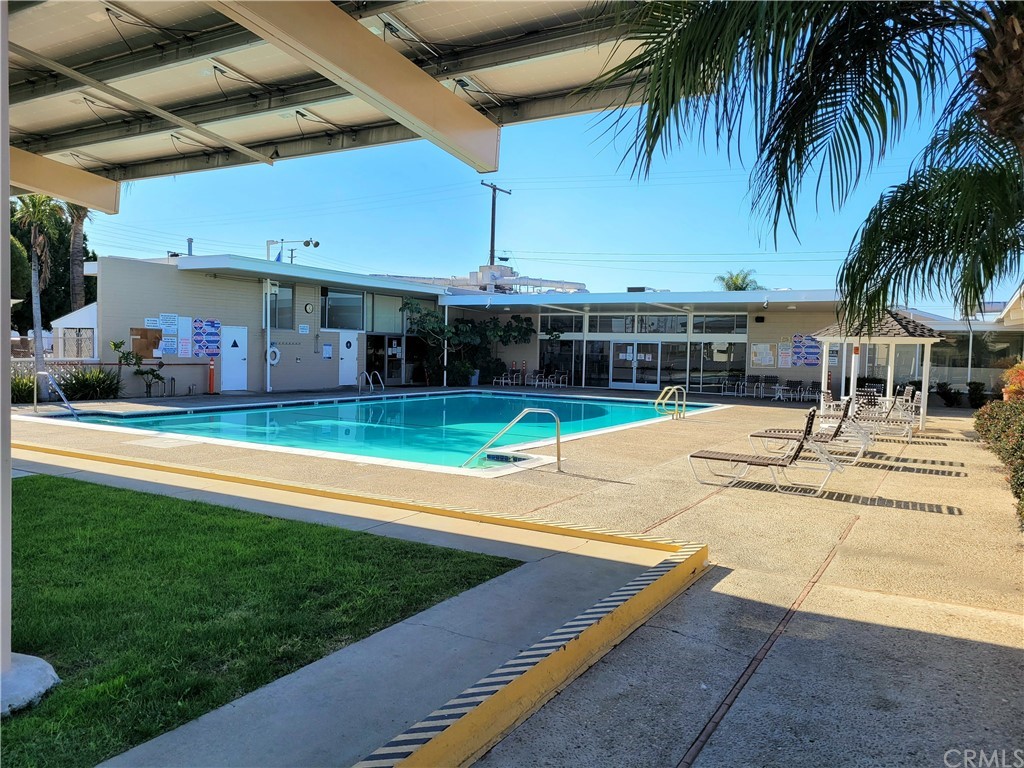 32 Walnut Via Anaheim, CA 92801 - Photo 19 of 24 a view of a swimming pool with a lawn chairs under an umbrella