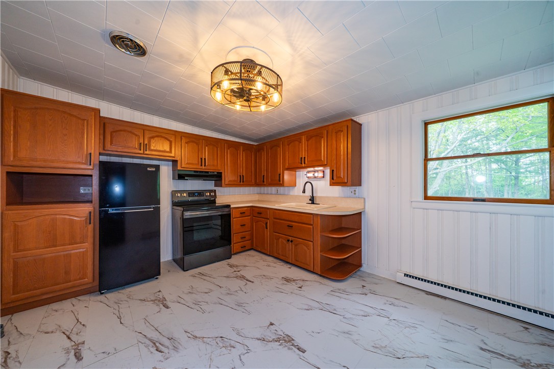 11296 Pansing Road Brookville, OH 45309 - Photo 9 of 53 This spacious kitchen offers ample cabinet storage and a practical layout for daily living.