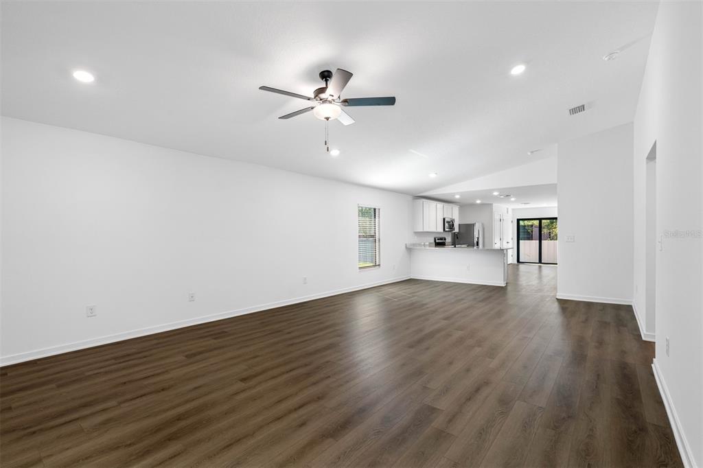 229 Galaxy Avenue Spring Hill, FL 34606 - Photo 2 of 9 a view of a kitchen with wooden floor and windows
